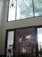 the big tree outside the dining is visible through the large glass windows at the upper level.